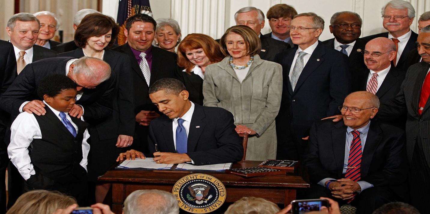 President Obama signing the ACA bill 